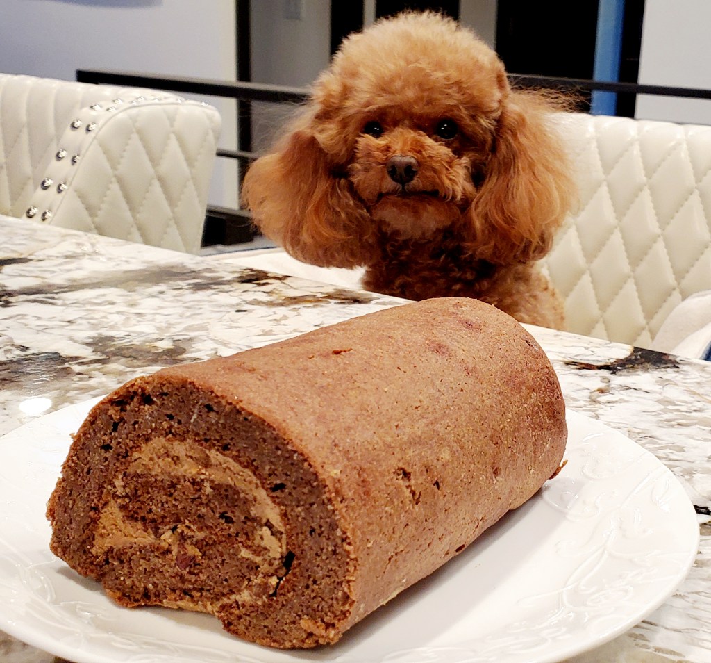 a picture of keto chocolate cake roll with coffee cream and cacao nibs